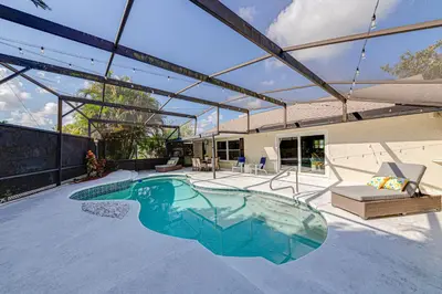 a swimming pool in the middle of a house at Beautiful home, centrally located to Parks with Pool in Orlando