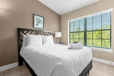 a bedroom with a large bed and a large window at Vibrant 4BR Family Townhome 1 mile from Disney World and Disney Springs in Orlando