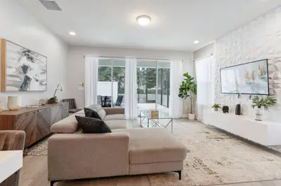 a living room with a couch and a table at Amazing 4 Bedrooms Next to DisneyPrivate Pool in Orlando