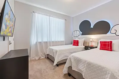 a hotel room with two beds and a window at Amazing 4 Bedrooms Next to DisneyPrivate Pool in Orlando