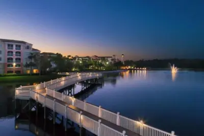 a bridge over a body of water at night at Marriott Grande Vista Luxury Studio in Orlando
