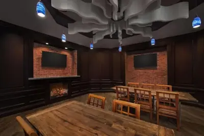 a room with a table and chairs and a fireplace at Marriott Grande Vista Luxury Studio in Orlando
