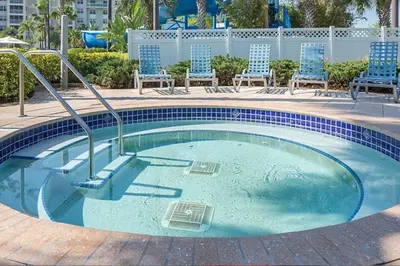 a swimming pool with chairs and chairs in it at Enjoy your AM coffee in resort relaxation garden in this great 1BD condo in Orlando in Orlando