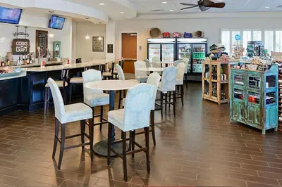 a restaurant with a bar with chairs and tables at Enjoy your AM coffee in resort relaxation garden in this great 1BD condo in Orlando in Orlando