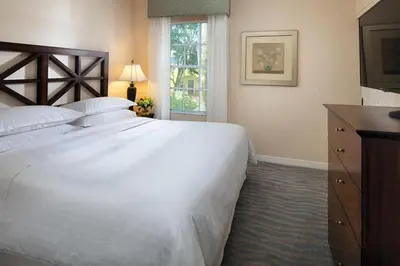 a bedroom with a large white bed and a window at Relax after the Orlando parks in this 1BD resort condo with pools, restaurants, activities etc in Orlando