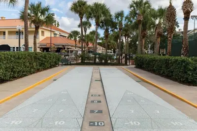 a walkway with palm trees and a building at Relax after the Orlando parks in this 1BD resort condo with pools, restaurants, activities etc in Orlando