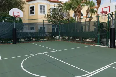 a tennis court in front of a house at Relax after the Orlando parks in this 1BD resort condo with pools, restaurants, activities etc in Orlando