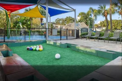 a backyard with a lawn with balls on it at Have fun in this 2BD condo in a resort setting with close access to Orlando parks in Orlando