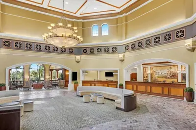 a large lobby with a couch and tables and a chandelier at Relax after enjoying all the parks Orlando has to offer in this 1BD vacation condo in Orlando