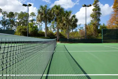 a tennis net on a tennis court at Family fun in this 2BD condo with multiple pools, mini golf, restaurants etc onsite in Orlando