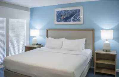 a bedroom with a large bed with two night stands and two lamps at Diamond Barefootn Resort 2BD in Orlando