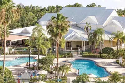 an aerial view of a resort with a pool and palm trees at WorldMark Kingstown Reef - Studio Sleeps up to 2 in Orlando