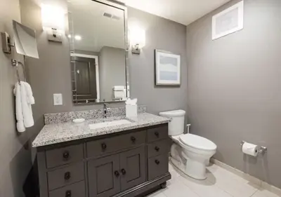 a bathroom with a sink and a toilet and a mirror at WorldMark Kingstown Reef - Studio Sleeps up to 2 in Orlando