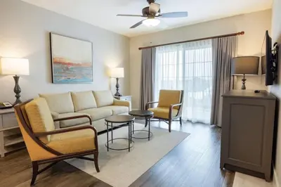 a living room with a couch and chairs and a table at WorldMark Kingstown Reef - Studio Sleeps up to 2 in Orlando