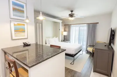 a hotel room with a king sized bed and a kitchen at WorldMark Kingstown Reef - Studio Sleeps up to 2 in Orlando