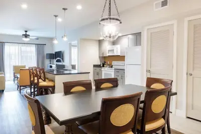 a kitchen and dining room with a table and chairs at WorldMark Kingstown Reef - 1BD Sleeps up to 4 in Orlando