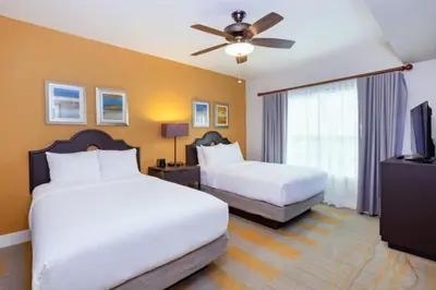 a hotel room with two beds and a ceiling fan at WorldMark Kingstown Reef - 2BD Sleeps up to 6 in Orlando
