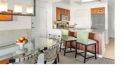 a kitchen with a table and chairs and a counter at Marriott Grande Vista 2BD villa sleeps 8 in Orlando