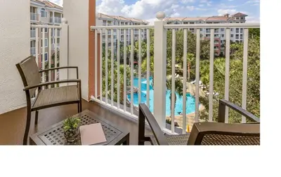 a balcony with chairs and a view of a pool at Marriott Grande Vista 2BD villa sleeps 8 in Orlando