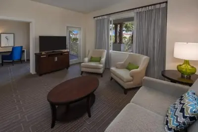 a living room with a couch and a tv at Marriott Grande Vista 2BD villa sleeps 8 in Orlando