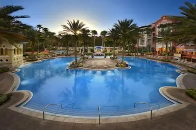 a large pool at a resort with palm trees at Marriott Grande Vista 2BD villa sleeps 8 in Orlando