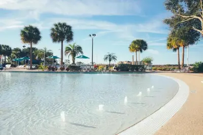 a pool on the beach with ducks in the water at Studio Apt in Orlando resort onsite pools, golf, arcades, cabanas etc. in Orlando
