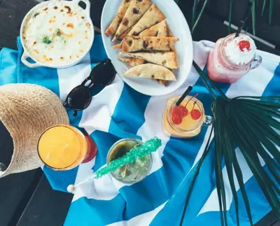 a table topped with plates of food and drinks at Studio Apt in Orlando resort onsite pools, golf, arcades, cabanas etc. in Orlando