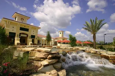 a resort with a waterfall in front of a building at Near Disney 1BD vacation condo in beautiful resort with lots of amenities in Orlando