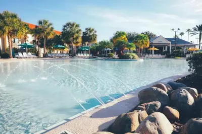 a swimming pool with a fountain in a resort at Enjoy Orlando Family Getaway in 2BD condo with lots of onsite activities in Orlando