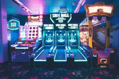 a video game room with arcade machines and signs at Enjoy Orlando Family Getaway in 2BD condo with lots of onsite activities in Orlando