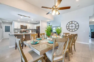a dining room and kitchen with a table and chairs at 5 Mi to Disney World Spacious Kissimmee Home! in Kissimmee