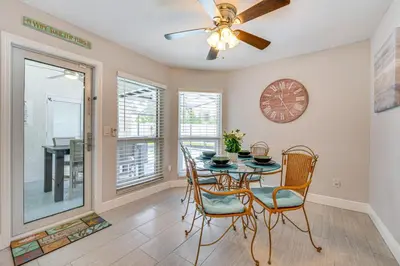 a dining room with a table and chairs and a ceiling fan at 5 Mi to Disney World Spacious Kissimmee Home! in Kissimmee