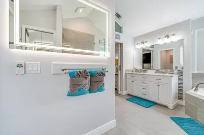 a bathroom with a sink and a mirror at 5 Mi to Disney World Spacious Kissimmee Home! in Kissimmee
