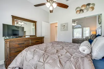 a bedroom with a large bed and a television at 5 Mi to Disney World Spacious Kissimmee Home! in Kissimmee