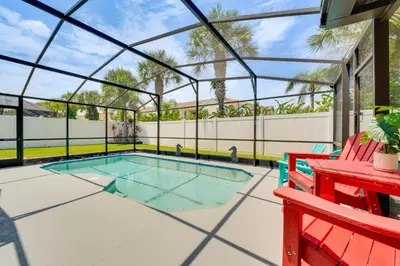 a swimming pool in a glass house with a red bench at 5 Mi to Disney World Spacious Kissimmee Home! in Kissimmee