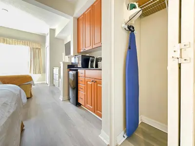 a room with a blue tie hanging on a wall at Double King Bed Suite, 5 Min from Universal, I-Drive & Outlets in Orlando