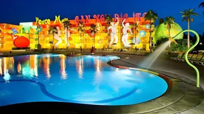 a large swimming pool in front of a hotel at Disney's Pop Century Resort in Orlando