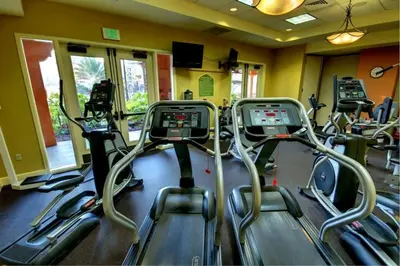 a gym with several cardio bikes in a room at Beautiful Resort in Bonnet Creek 1BD Deluxe near Walt Disney World in Orlando
