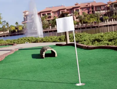 a putting green with a white sign and a fountain at Beautiful Resort in Bonnet Creek 1BD Deluxe near Walt Disney World in Orlando
