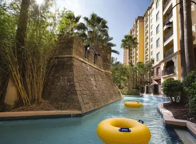 a pool with two inflatable boats in the water at Beautiful Resort in Bonnet Creek 1BD Deluxe near Walt Disney World in Orlando