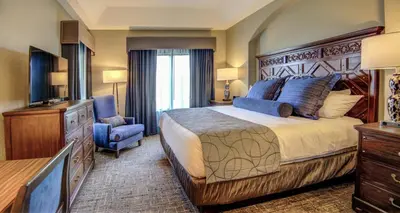 a hotel room with a large bed and a television at Beautiful Resort in Bonnet Creek 2BD Deluxe near Walt Disney World in Orlando