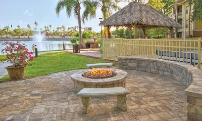 a fire pit in the middle of a patio with a fountain at Beautiful Hotel of Cypress Palms 1BD near Kissimmee Lakefornt Park in Kissimmee