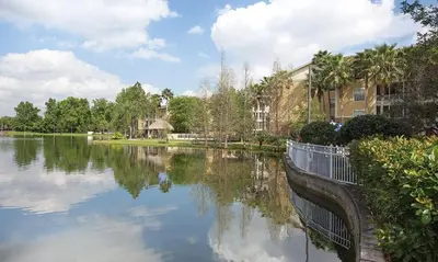 a body of water with houses and trees and buildings at Beautiful Hotel of Cypress Palms 2BD in Kissimmee