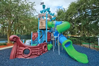 a playground with a slide in a park at Beautiful Resort in Star Island 2BD near at Lake Cecile in Kissimmee
