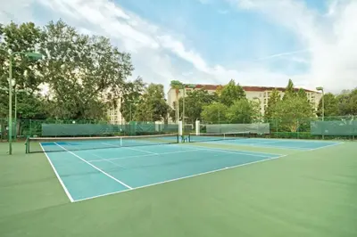 a tennis court with two tennis rackets on it at Beautiful Resort in Star Island 2BD near at Lake Cecile in Kissimmee