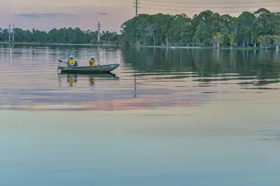 two people in a boat on a large body of water at Diamond Bryans Spanish Cove 2BD in Orlando