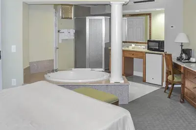 a hotel room with a bed and a bath tub at Diamond - Cypress Pointe Resort - St in Orlando