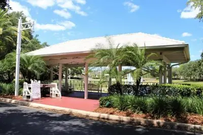 a pavilion with a table and chairs on a red rug at Diamond - Cypress Pointe Resort - 2BD in Orlando