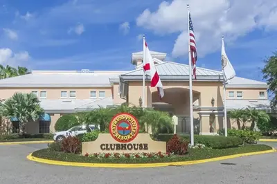 a hotel with flags in front of a building at Diamond - Cypress Pointe Resort - 2BD in Orlando