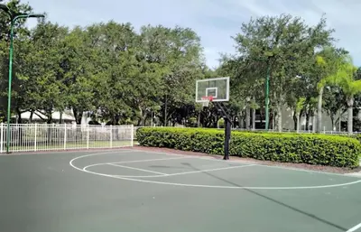 a basketball hoop in a park with trees at Diamond - Cypress Pointe Resort - 2BD in Orlando